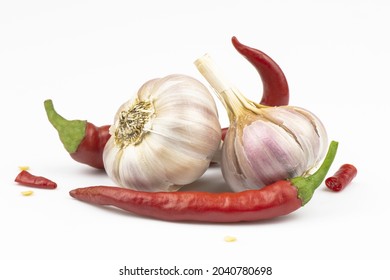 Garlic heads and red hot peppers isolated on a white background. - Powered by Shutterstock