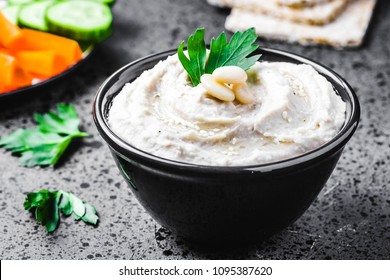 Garlic Herb White Bean Dip On Dark Concrete Background. Selective Focus, Space For Text. 