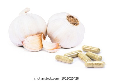 Garlic Herbal Powder Capsules And Garlic Bulb And Clove Isolated On White Background.