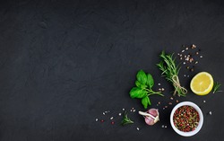 Garlic, Oil And Spices On Black Background. High Quality Photo