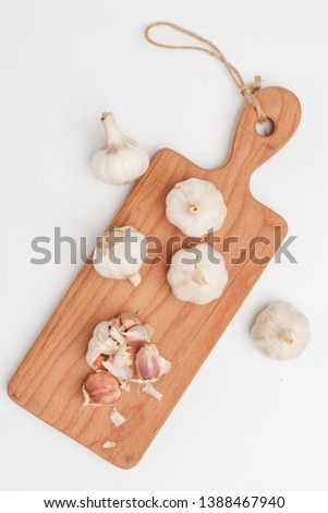 Garlic on a cutting wooden board. Top view.