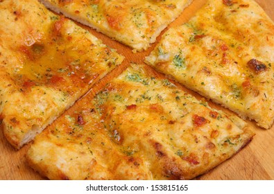 Garlic Pizza Bread With Sunblush Tomatoes And Herbs.