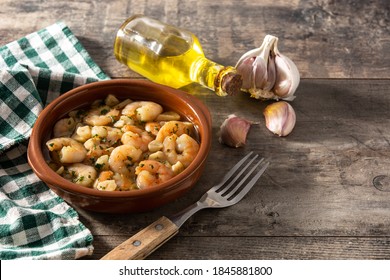 Garlic Prawns In Crockpot On Wooden Table.