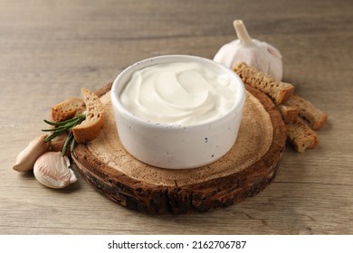 Garlic sauce, ingredients and snack on wooden background - Shutterstock ID 2162706787