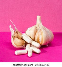 Garlic tablet to protect against viruses. garlic cloves and medicine on a bright pink background. Garlic and white tablets.  Herbal supplements.  Selective focus. - Powered by Shutterstock