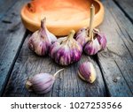 Garlic in wooden plates on a wooden table