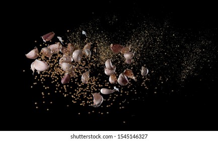 Garlic,various Spices, Pepper And Salt Splash Or Explosion Flying In The Air Isolated On Black,Stop Motion