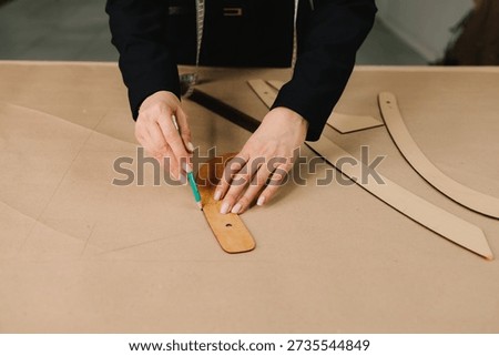 Garment drafting tools and patterns show fashion design workflow as designer drafts clothing