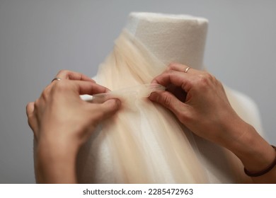 a garment getting pinned on a mannequin