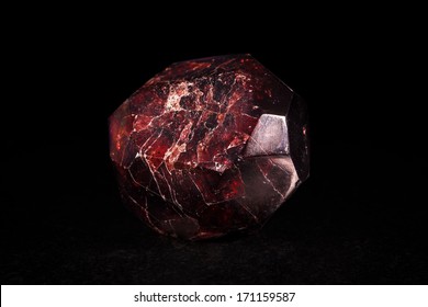 Garnet Crystal Stone In Front Of Black