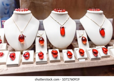 Garnet Jewelry And Earrings On A Showcase