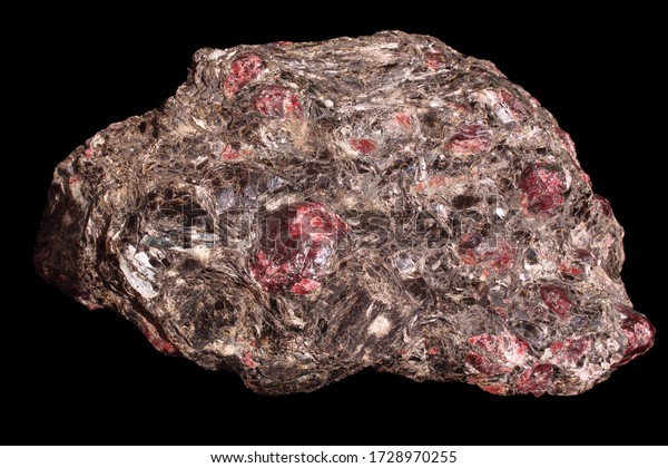 Garnet Mica-Schist sample. Almandine-garnets\
Crystals interspersed in a massive piece of shale rock, on a dark\
isolated background