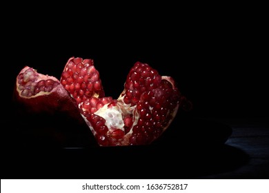 Garnet On A Black Plate On A Black Background In A Low Key