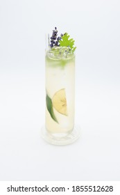 Garnished Gin And Tonic Cocktail With Bergamotte Lemon Annd Lavender In Beautiful Highball Longdrink Glass On White Background.