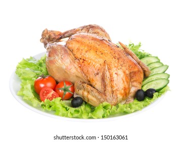 Garnished Roasted Thanksgiving Chicken On A Plate Decorated With Salad, Olives, Tomatoes, Cucumbers Isolated On A White Background