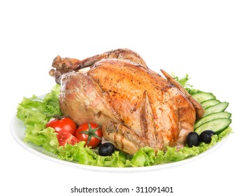 Garnished Roasted Thanksgiving Chicken On A Plate Decorated With Salad Olives Tomatoes Cucumbers Isolated On A White Background