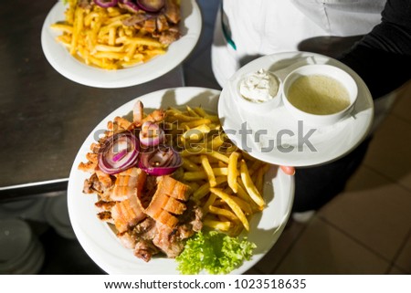 Garson serving two dishes