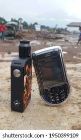 Garut, Indonesia - 6 September 2016 - Old School Cellphone That Leans On Vaping Devices