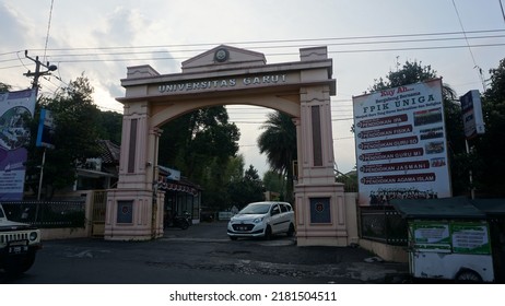 Garut, Indonesia - July 19th 2022 : The View Of The Gates Of The Garut University Campus, The Afternoon Atmosphere, It Can Be Seen Vehicles Going Back And Forth And Street Vendors' Carts And Billboard