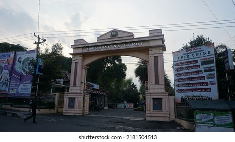 Garut, Indonesia - July 19th 2022 : The View Of The Gates Of The Garut University Campus, The Afternoon Atmosphere, It Can Be Seen Vehicles Going Back And Forth And Street Vendors' Carts And Billboard