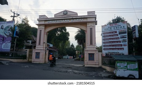 Garut, Indonesia - July 19th 2022 : The View Of The Gates Of The Garut University Campus, The Afternoon Atmosphere, It Can Be Seen Vehicles Going Back And Forth And Street Vendors' Carts And Billboard