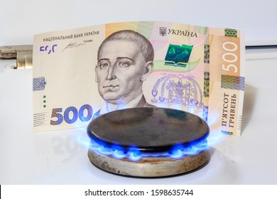 Gas Burner, A Fire Burns, In The Background Five Hundred Hryvnia. The Concept Of Gas Prices In Ukraine.