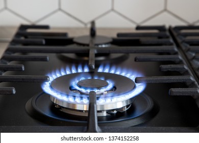 Gas burner on black modern kitchen stove. kitchen gas cooker with burning fire propane gas