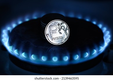 Gas burner and ruble coin, Russian money on home gas stove. Blue propane flame and ruble currency. Concept of Russia and Europe economy, oil, cost, inflation, sanctions, Gazprom, embargo and crisis.