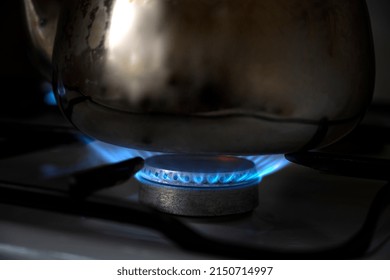 The gas is burning. Gas burns on the whip. Kitchen stove. The cooking zone is on. Dangerous gas. Gas burns in the kitchen