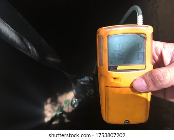 Gas Detector In Hand, Measuring Air Before Going To Confined Space Work.