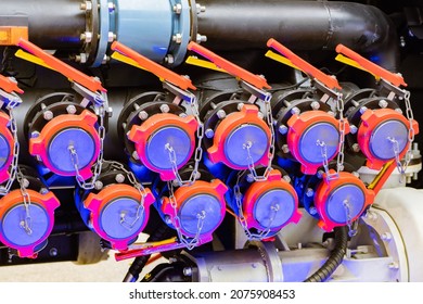 Gas Equipment Close-up. Many Valves On Gas Pipe. Butterfly Valves Are Attached With Chain. Gasification Equipment. Fragment Of Boiler Equipment. Butterfly Valves On Pipes Of Enterprise