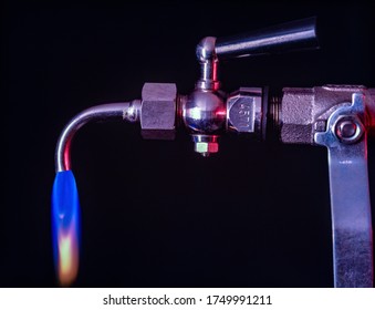 A Gas Faucet With A Blowing Flame On A Black Background That Can Also Be Used As A Concept Pic