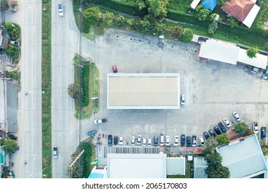 Gas or filling station building in aerial view. May call petrol pump. Include car park, road, mart or store. To service by refueling energy, oil, gasoline, diesel for car, auto. Transport industry.