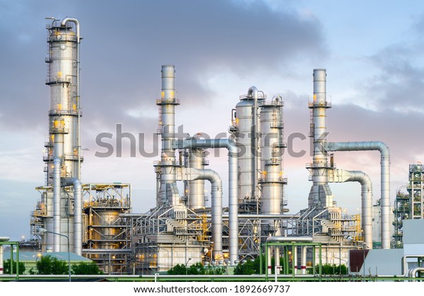Gas fired power plant and factory building at\
night. Also called gas fired power station or natural gas power\
plant. That technology to burn natural gas and generate electricity\
or electrical energy.