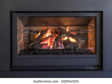 Gas Fireplace, Logs And Flames In Black Metal Frame