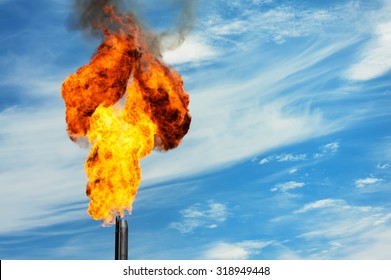 Gas flaring. Torch against the sky.