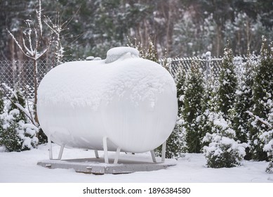 Gas Fuel Tank For Home Heating. Winter In The Countryside And A Container For Egological Fuel For Heating. Gas Installation On The Plot.