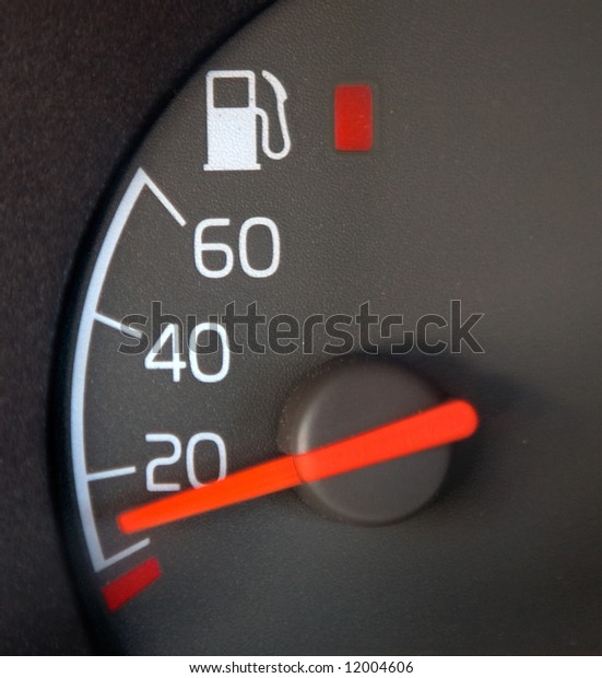 Gas\
Gauge showing nearly empty with red warning\
light