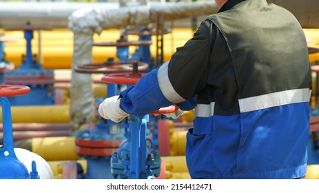 Gas Industry, Gas Transmission System And Gas Pipeline. Communications, A Worker Opens And Closes Shut-off Valves At A Gas Pumping Station. Selective Focus.