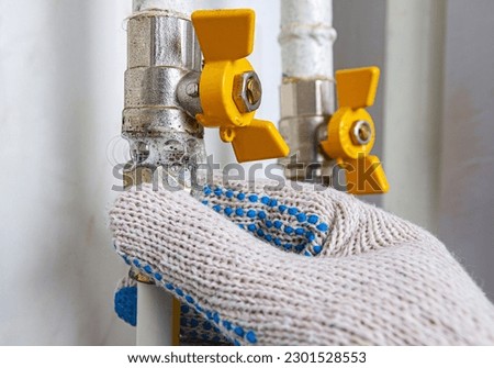 Gas leak at home. Inflating bubbles of soap mixture applied to the threaded joint on the gas pipe indicate a gas leak. Preventing a gas explosion disaster.