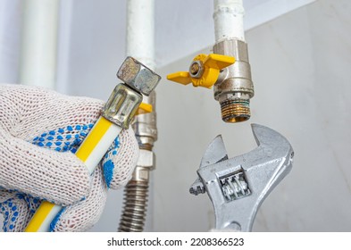 Gas Leak Repair. A Technician Is Replacing Or Connecting A Gas Hose.