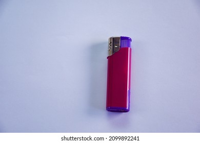 Gas Lighter Purple On A Light Gray Background. Close-up Of A Surface For Your Design. Empty Gas Plastic Lighter Mockup Element. Close-up, Top View.