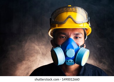 Gas mask. Respirator cartridge. Man in factory with backdrop - close up - Powered by Shutterstock