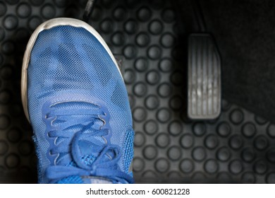 The Gas Pedal Brake Pedal On The Blue Shoes.