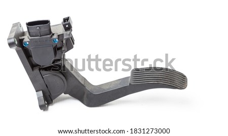 Gas pedal on a white isolated background in a photo studio for sale in a car service. Black auto part for replacement during repair in the workshop. Spare part junkyard.
