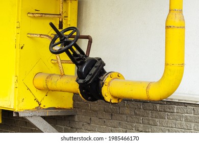 Gas Pipe On The Facade Of An Apartment Building. A Valve For Shutting Off The Supply Of Energy Resources In The Event Of An Emergency And Pipeline Repair. Close-up