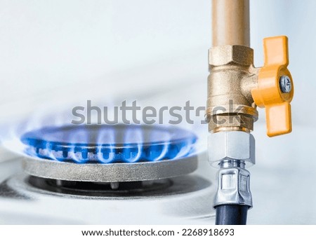 gas pipe with open yellow valve and burning gas burner, double exposure of natural gas use
