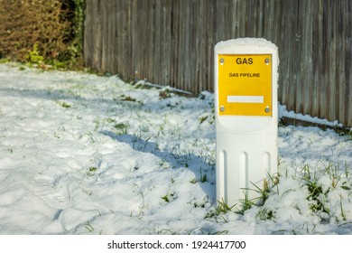 Gas Pipeline Marker Under Winter Snow In England Uk.