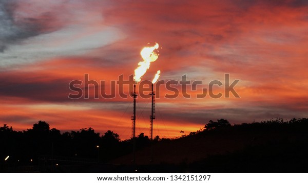 Gas plant flare\
stack.. Sunset flare stack