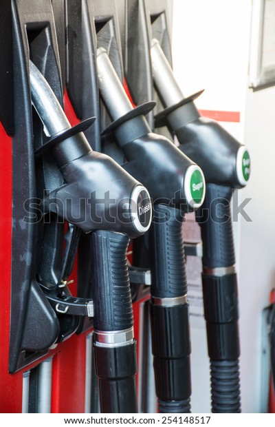 gas pump\
nozzles in a service station,\
upright
